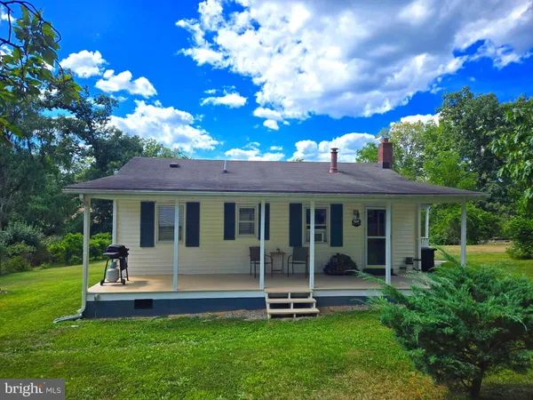 a view of a house with a backyard porch and sitting area