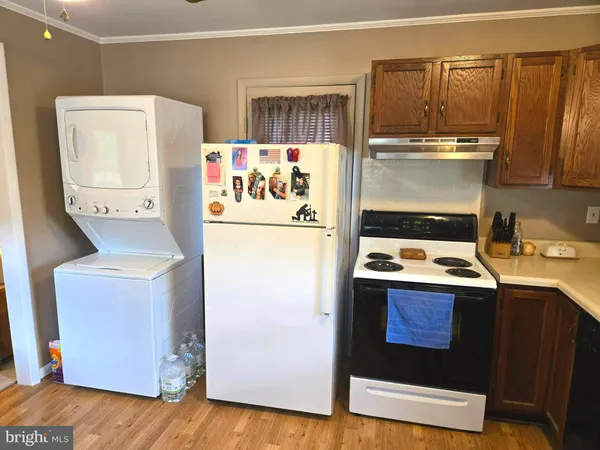 a kitchen with a refrigerator a stove a microwave and wooden floor