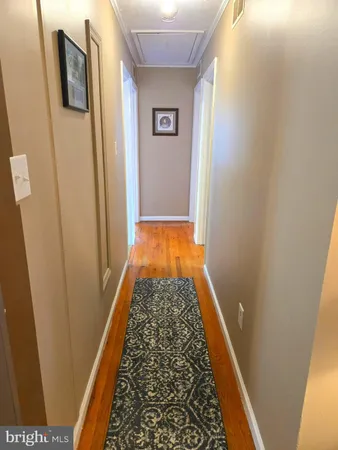 a view of hallway with wooden floor