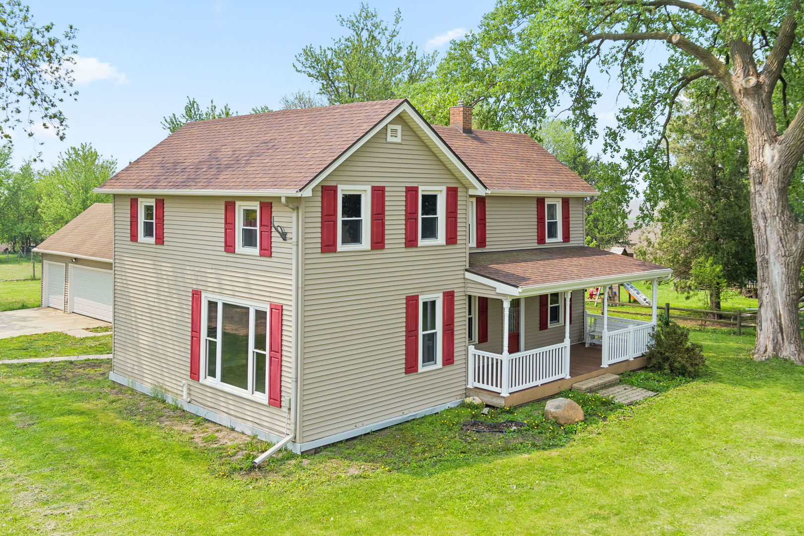 a aerial view of a house with a yard and deck