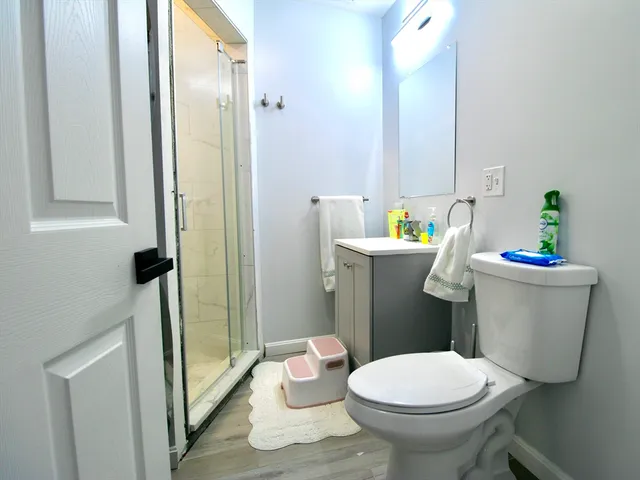 a bathroom with a sink toilet and shower