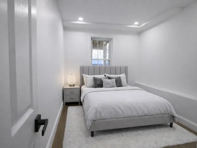 a bedroom with a bed and a window