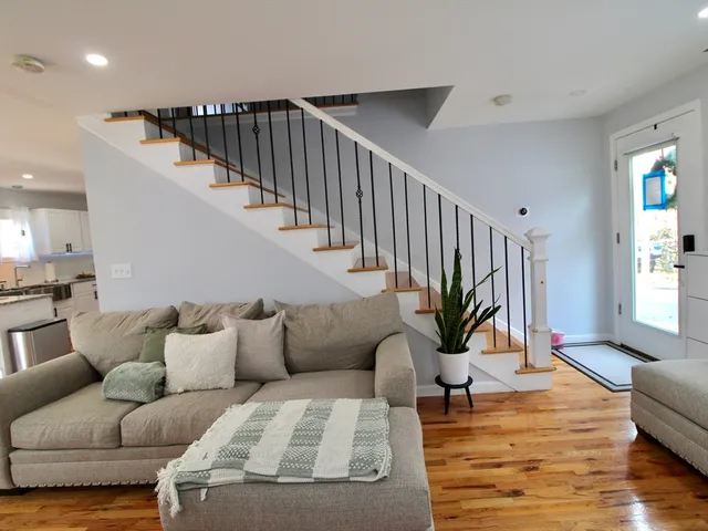 a living room with furniture or wooden floor and a potted plant