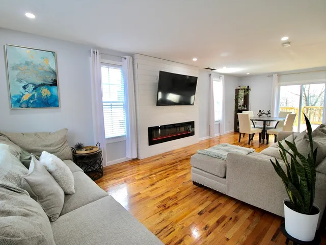 a living room with furniture fireplace and flat screen tv