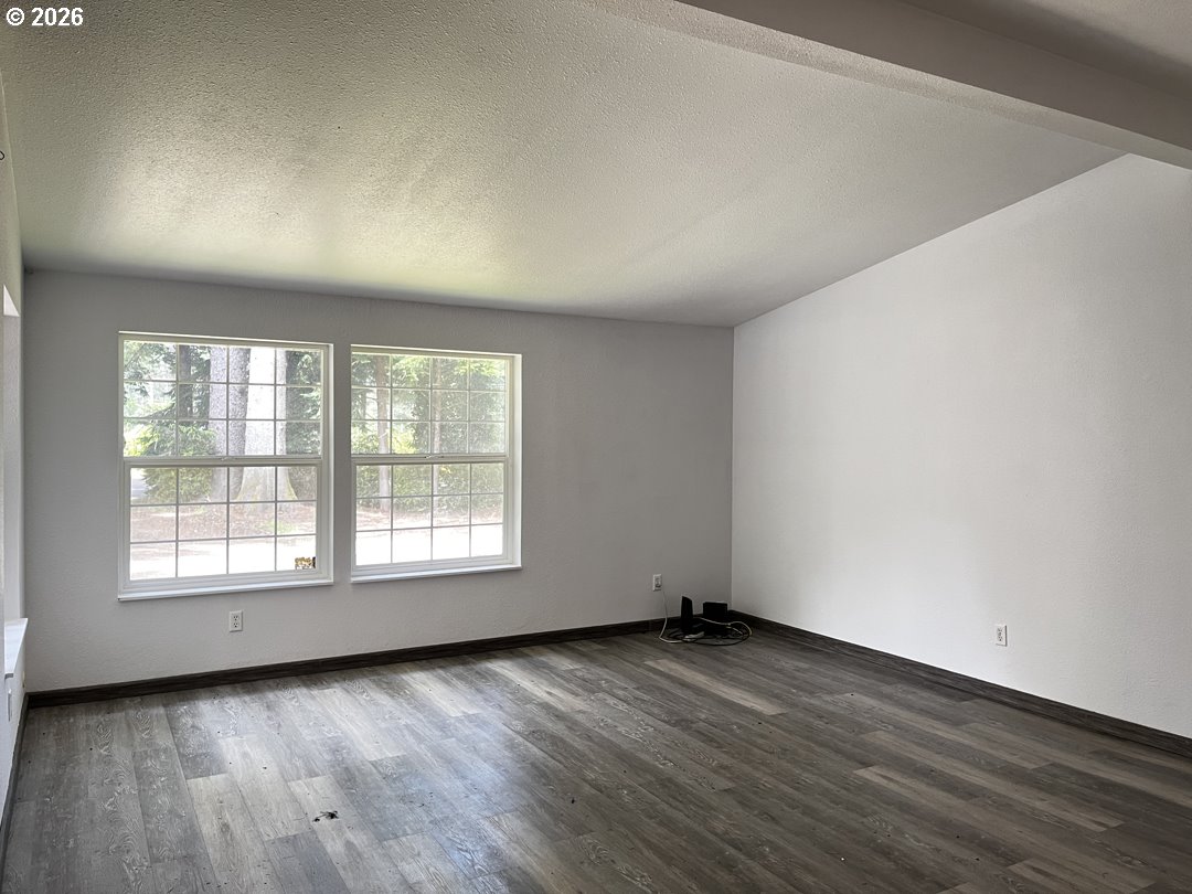 83411 Clear Lake Road Florence, OR 97439 - Photo 18 of 47 an empty room with wooden floor and windows