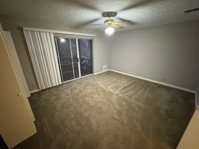 an empty room that has a grey walls