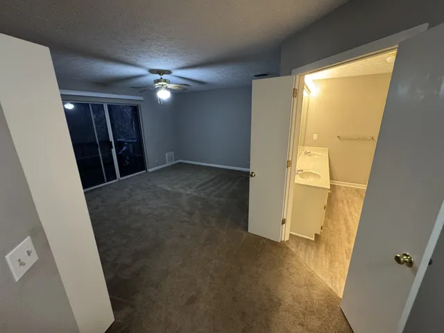 a view of empty room with wooden floor and cabinet