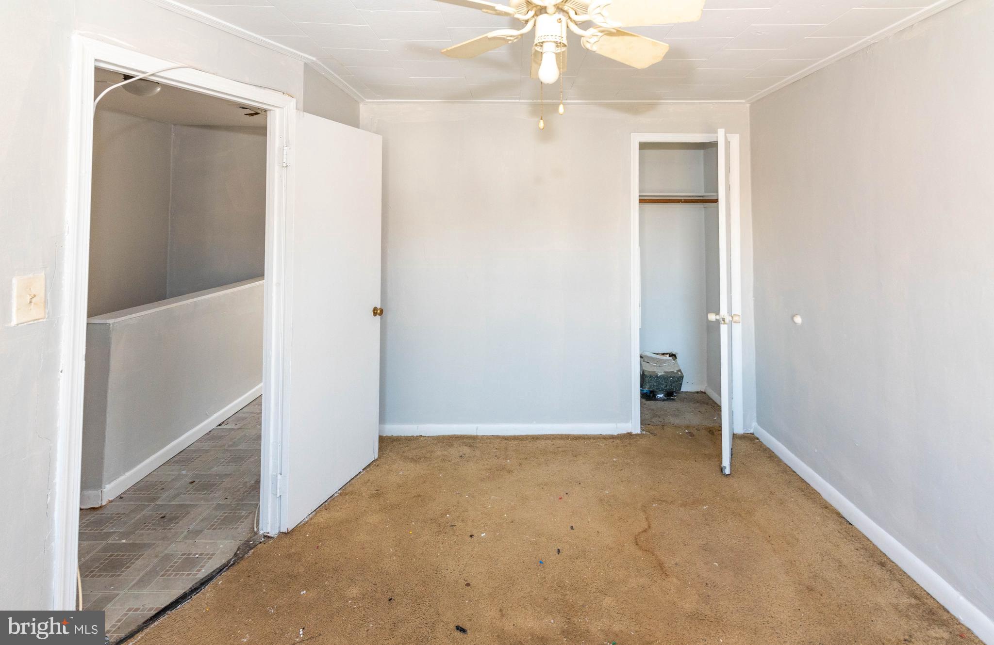2038 Larkhall Road Dundalk, MD 21222 - Photo 15 of 28 an empty room with fan and entrance