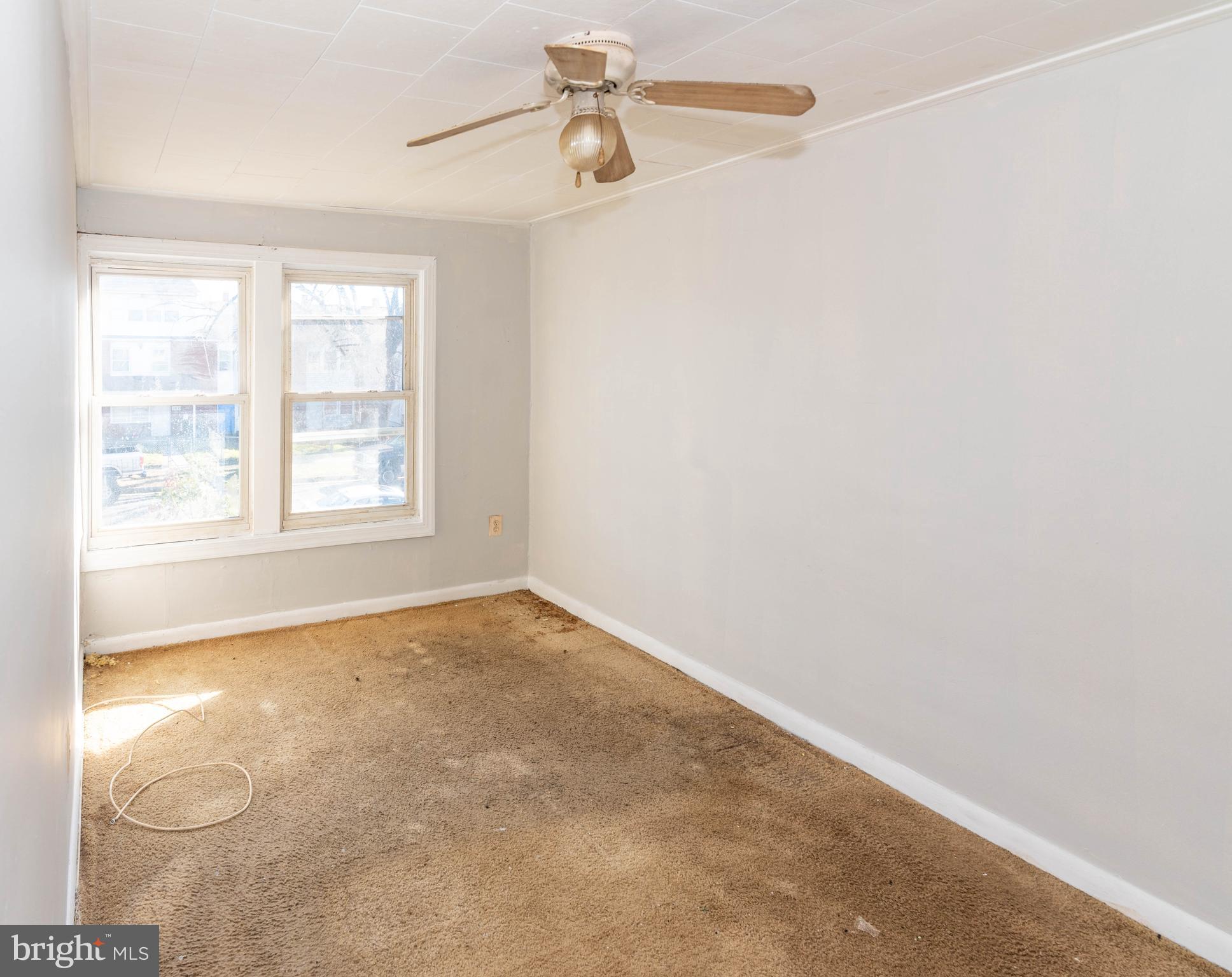 2038 Larkhall Road Dundalk, MD 21222 - Photo 17 of 28 an empty room with windows and ceiling fan