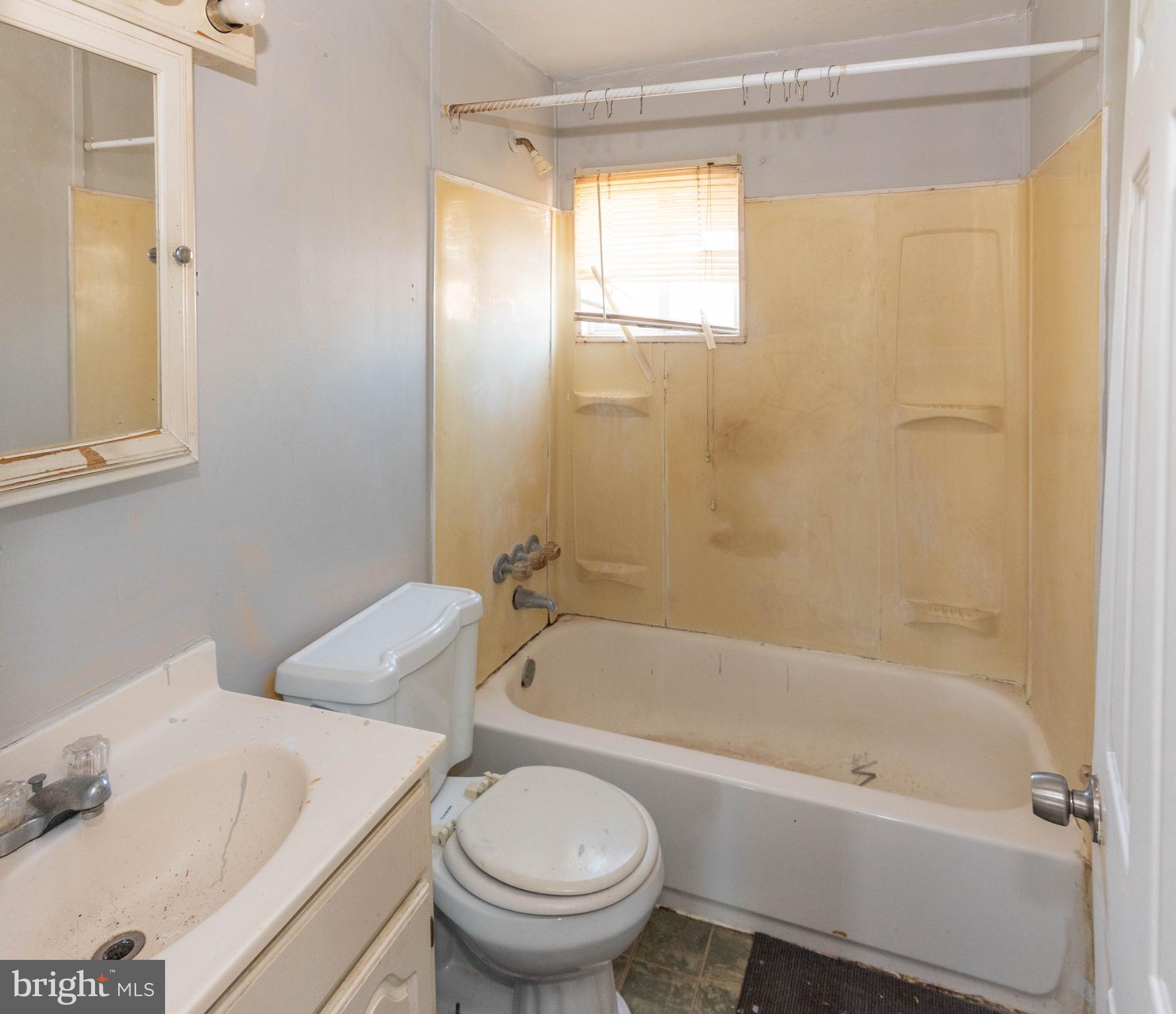 2038 Larkhall Road Dundalk, MD 21222 - Photo 19 of 28 a bath room with a toilet and a bath tub