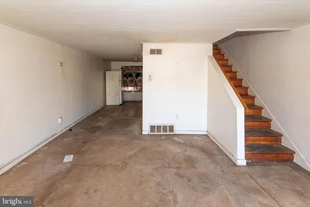 a view of a big room with entryway and stairs