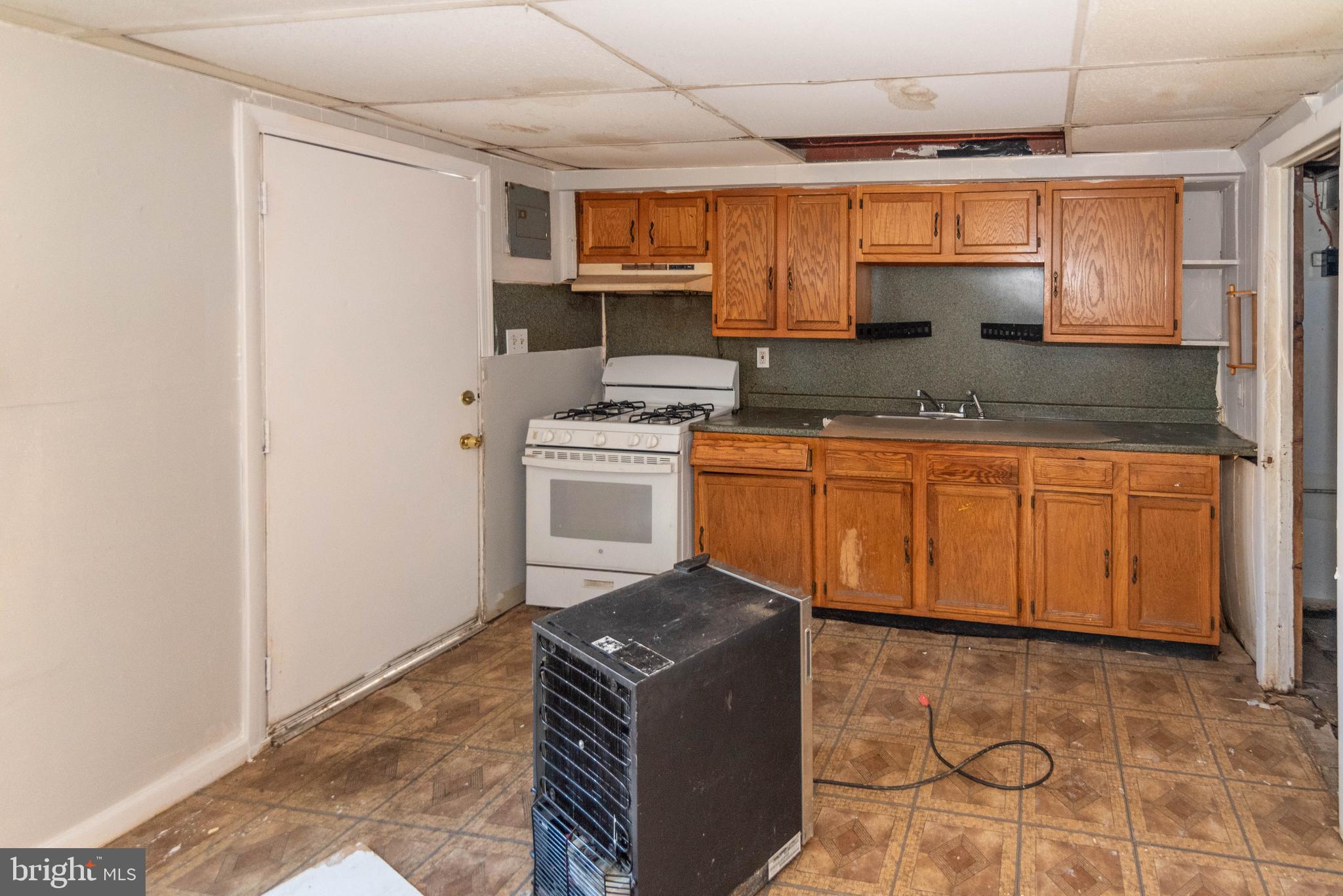 2038 Larkhall Road Dundalk, MD 21222 - Photo 8 of 28 a kitchen with stainless steel appliances granite countertop a stove a sink and a refrigerator