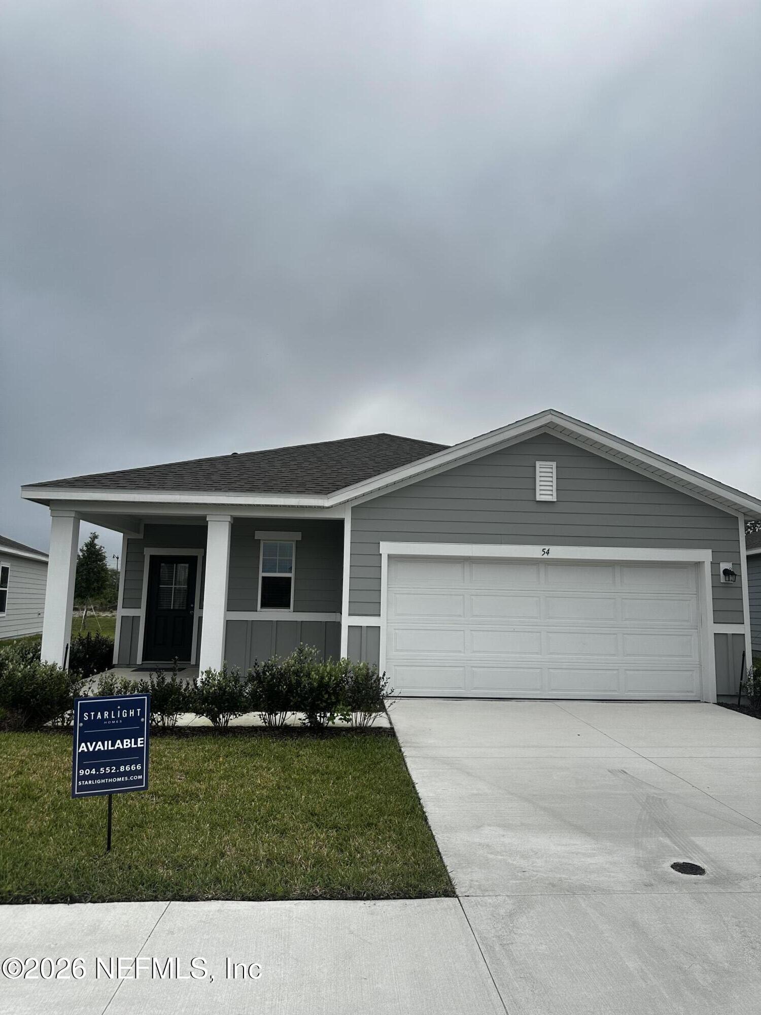 54 Oriole Road Palm Coast, FL 32137 - Photo 1 of 23 a front view of a house with a garden