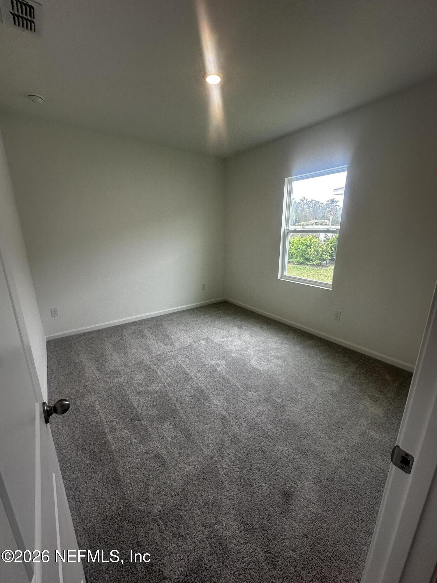 54 Oriole Road Palm Coast, FL 32137 - Photo 16 of 23 an empty room with a window