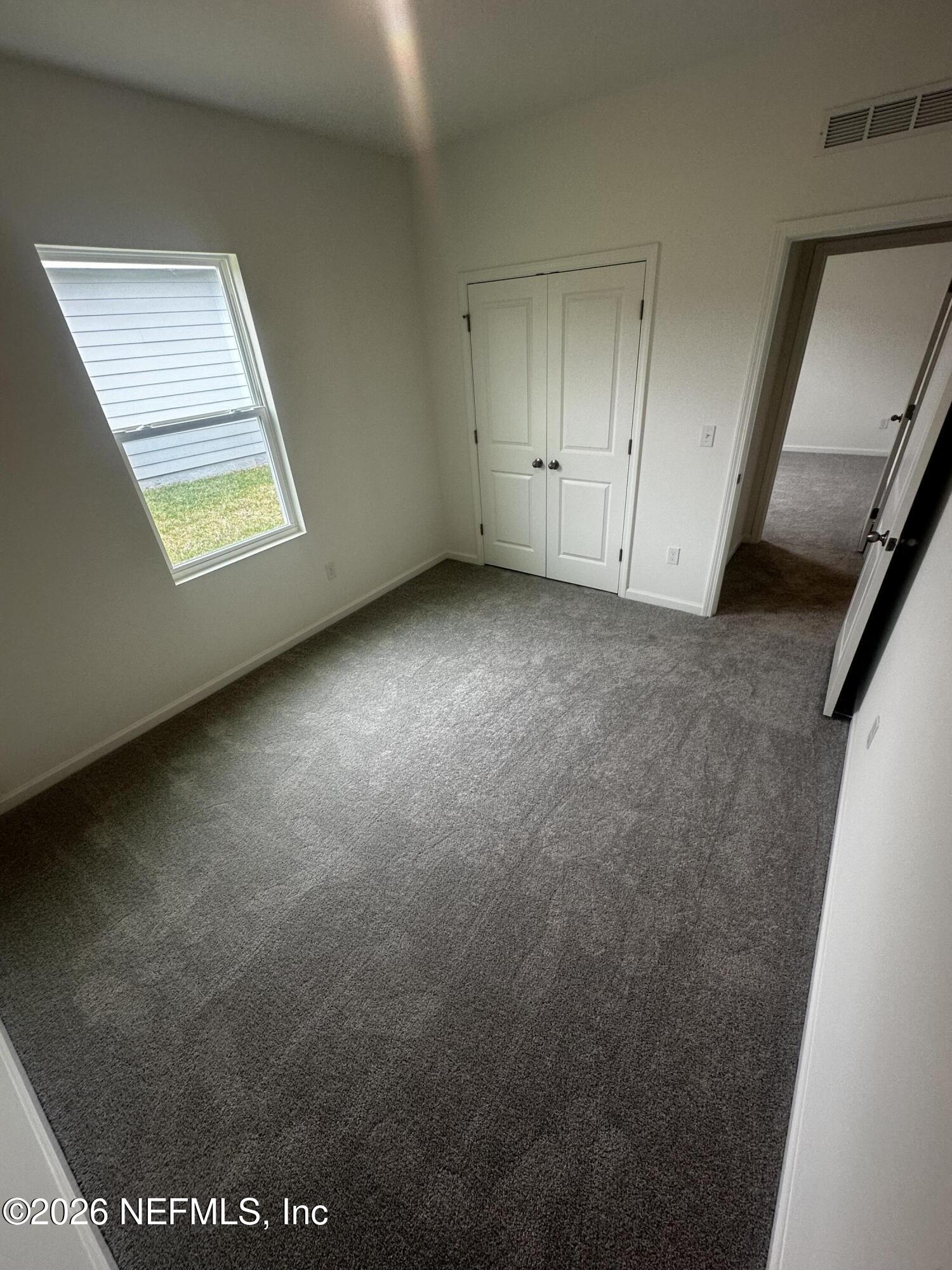 54 Oriole Road Palm Coast, FL 32137 - Photo 17 of 23 an empty room with windows