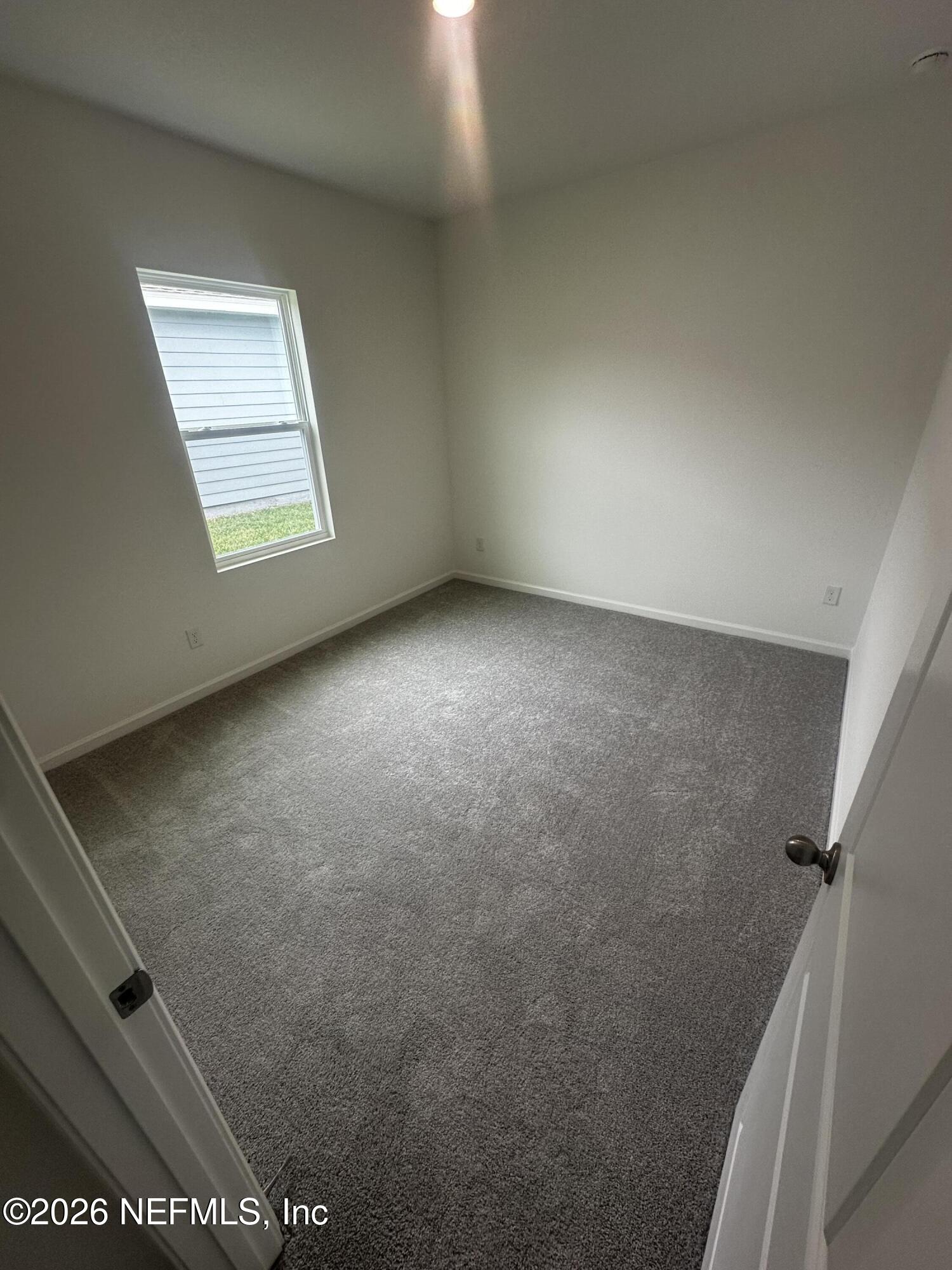 54 Oriole Road Palm Coast, FL 32137 - Photo 18 of 23 an empty room with windows