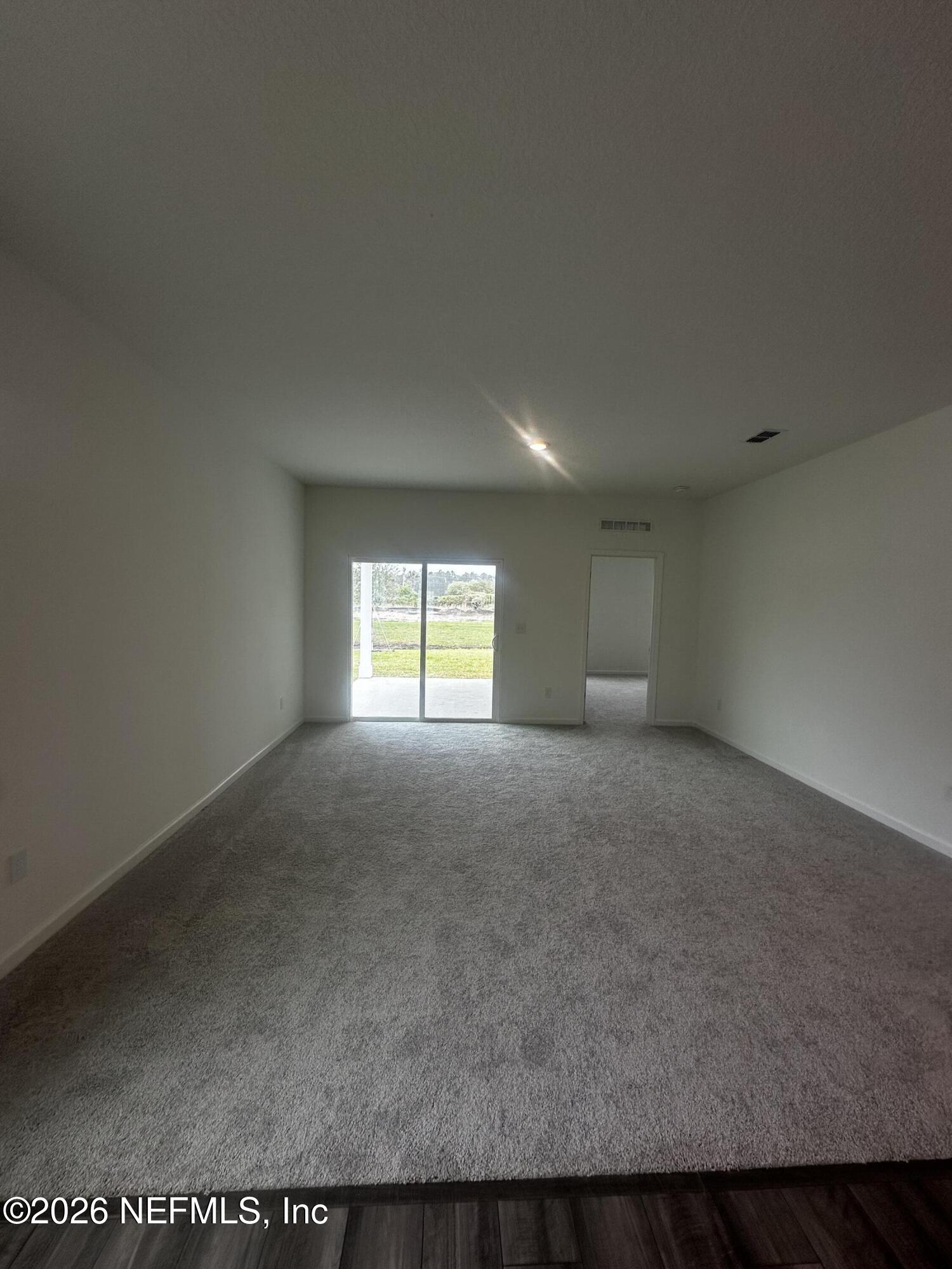 54 Oriole Road Palm Coast, FL 32137 - Photo 4 of 23 a view of empty room with a window