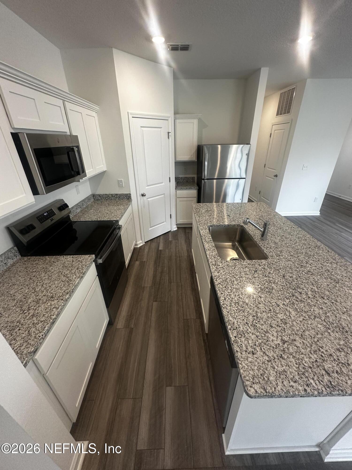 54 Oriole Road Palm Coast, FL 32137 - Photo 6 of 23 a kitchen with a sink stove and refrigerator