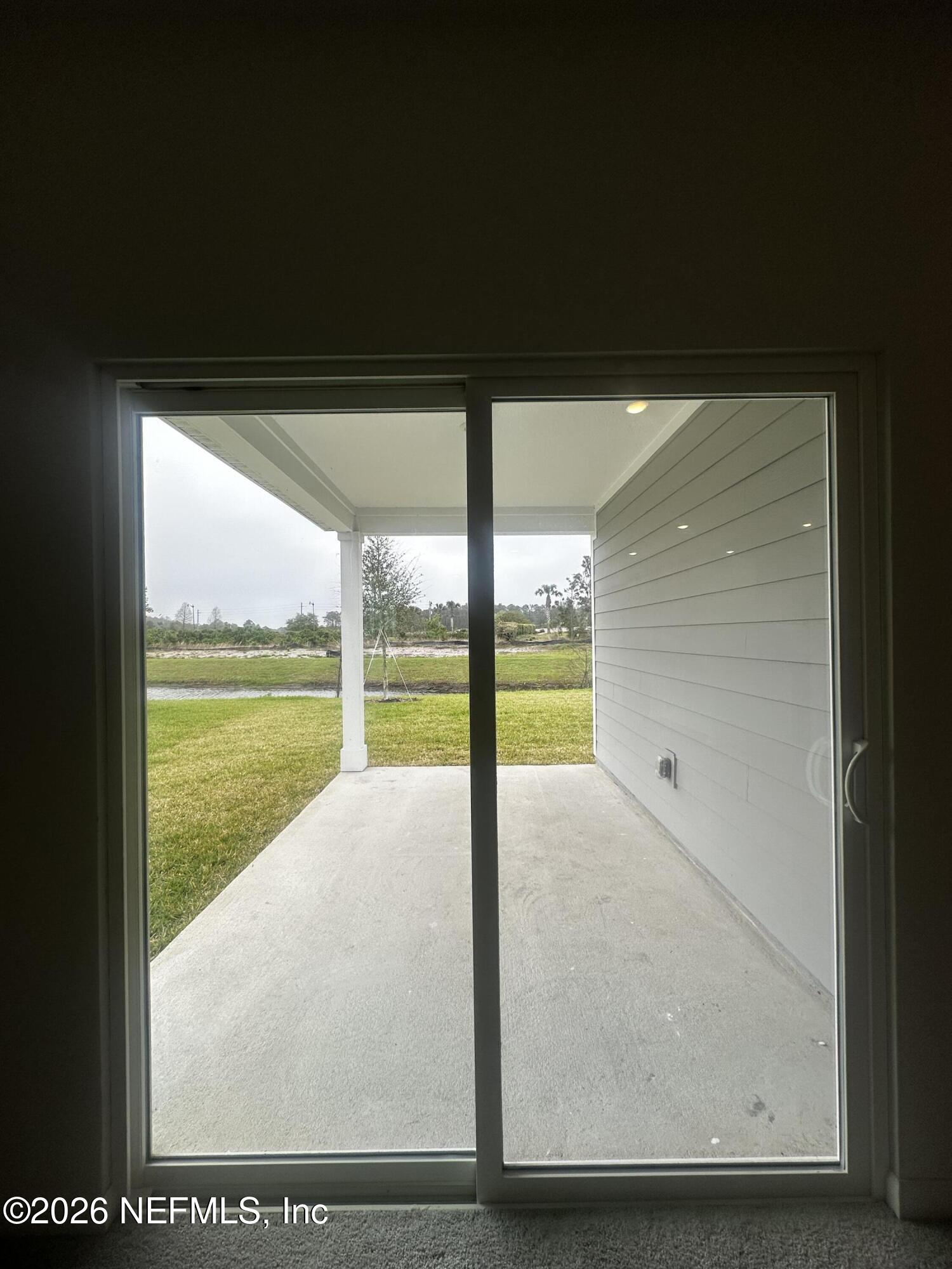 54 Oriole Road Palm Coast, FL 32137 - Photo 9 of 23 a view of a floor to ceiling window and an outdoor view