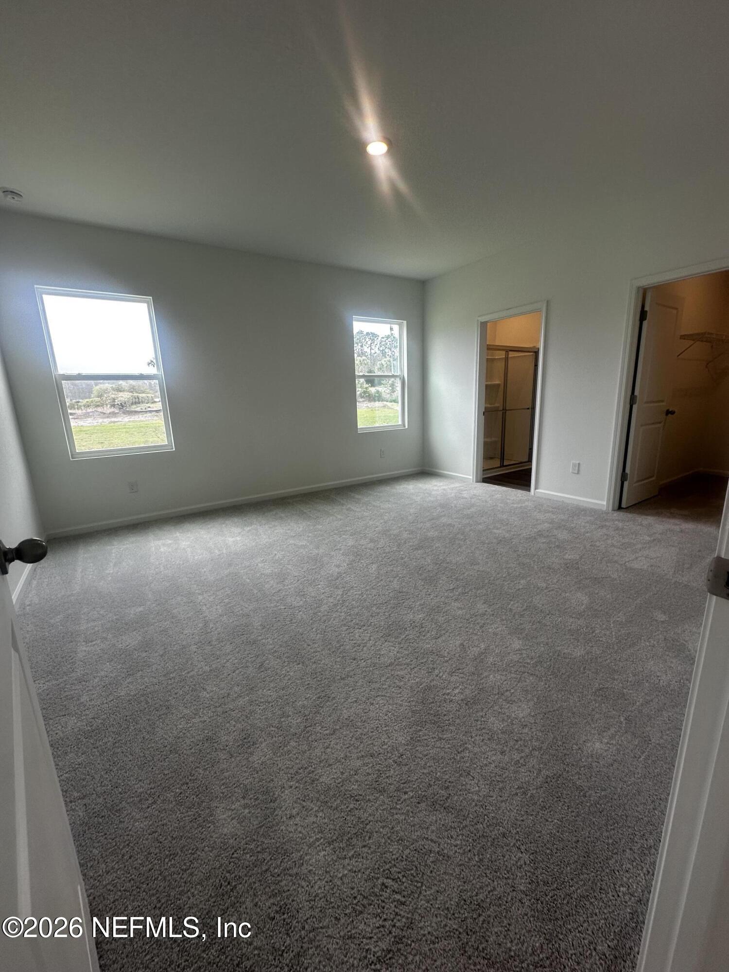 54 Oriole Road Palm Coast, FL 32137 - Photo 10 of 23 a view of empty room with window and wooden floor