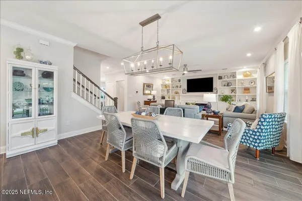a view of a dining room with furniture wooden floor and chandelier