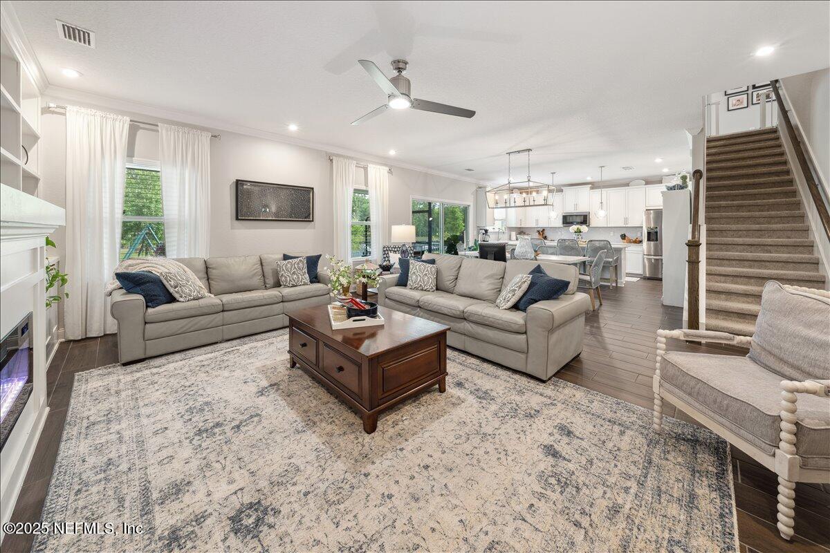 552 Meadow Creek Drive St. Johns, FL 32259 - Photo 15 of 62 a living room with furniture and a fireplace