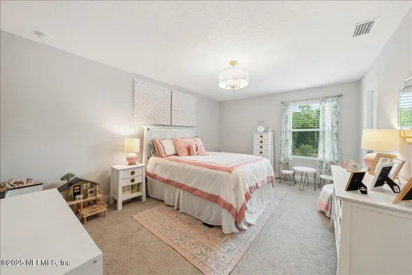 a view of a bedroom with furniture and windows
