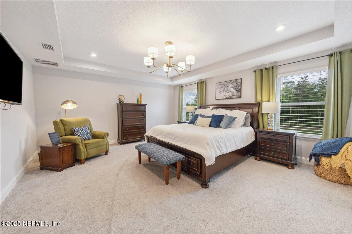 552 Meadow Creek Drive St. Johns, FL 32259 - Photo 22 of 62 a spacious bedroom with a bed and a couch