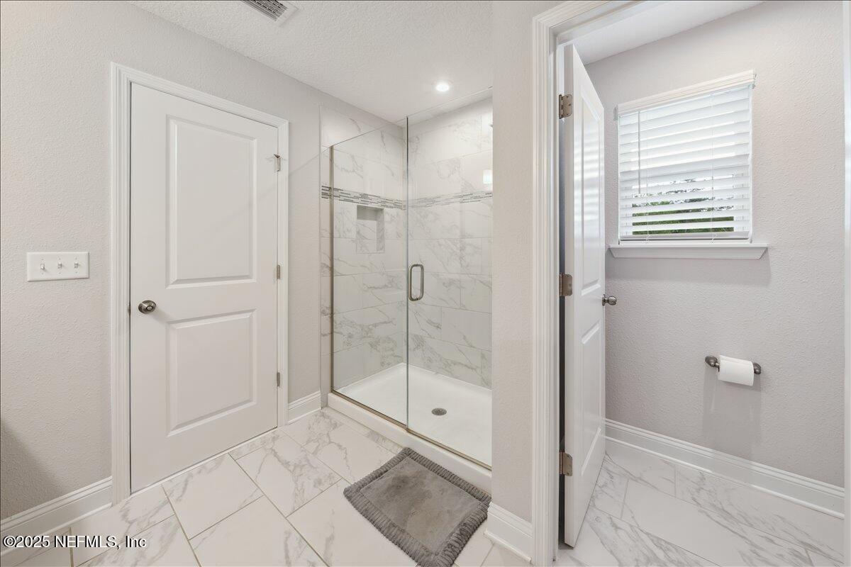 552 Meadow Creek Drive St. Johns, FL 32259 - Photo 27 of 62 a bathroom with a shower and a sink