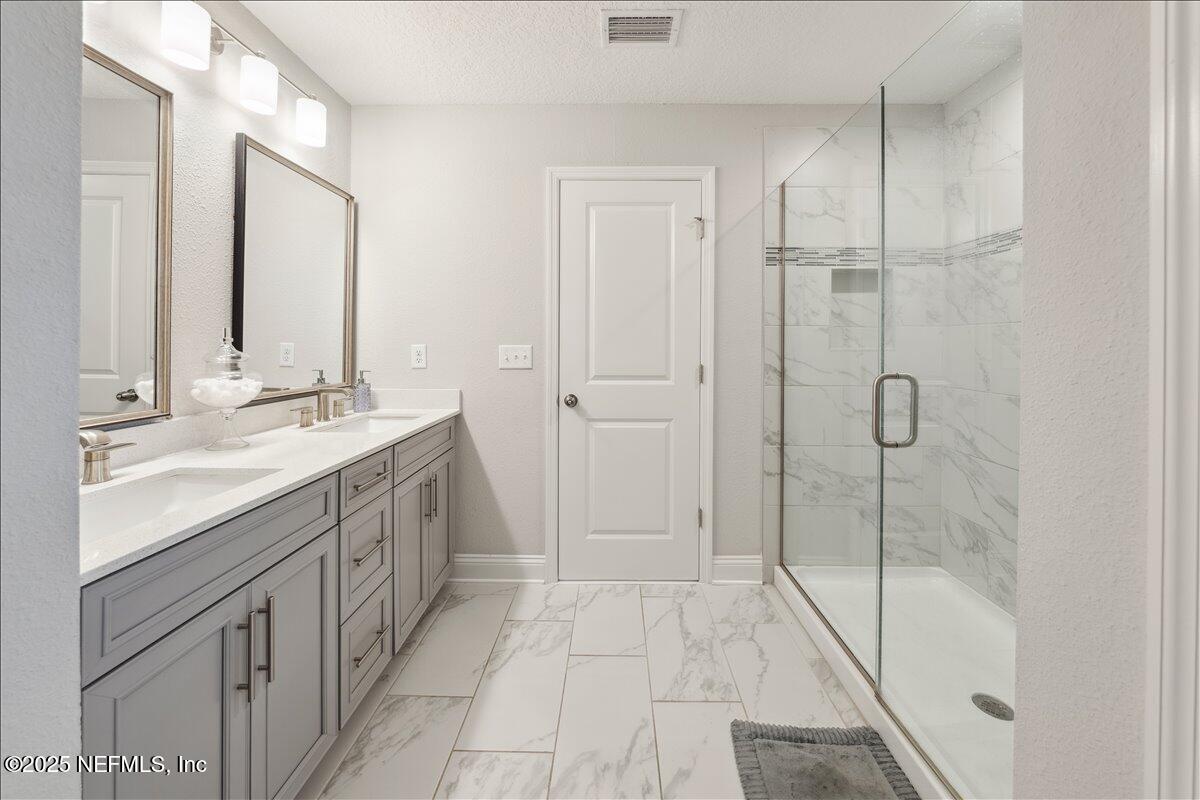 552 Meadow Creek Drive St. Johns, FL 32259 - Photo 28 of 62 a spacious bathroom with a shower sink and mirror