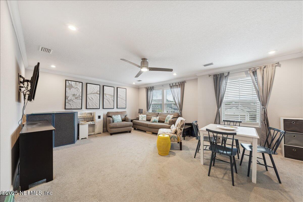 552 Meadow Creek Drive St. Johns, FL 32259 - Photo 30 of 62 a living room with furniture and a large window