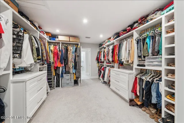 a view of a patio with couches table and chairs and potted plants