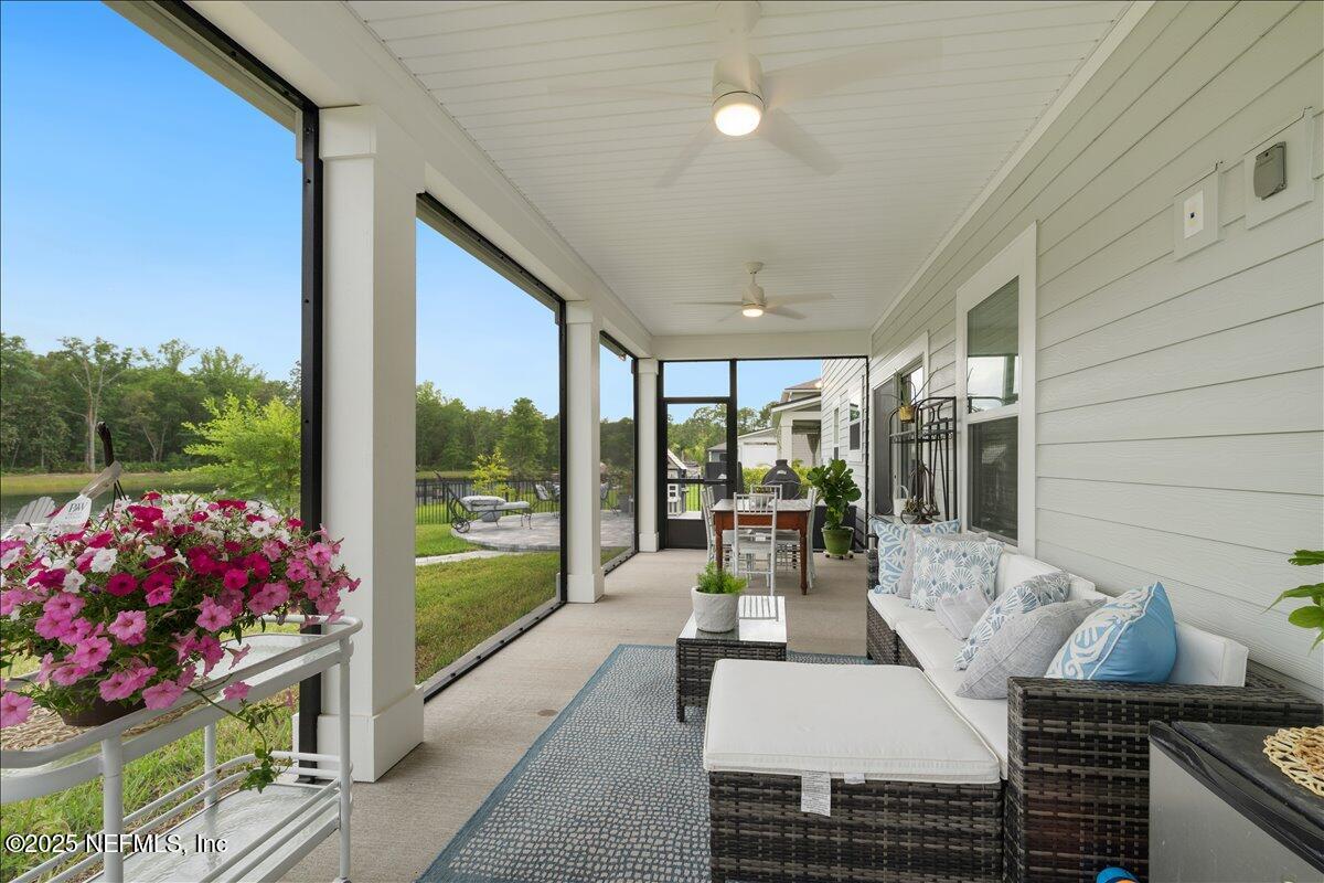 552 Meadow Creek Drive St. Johns, FL 32259 - Photo 36 of 62 a view of a patio with couches table and chairs and potted plants