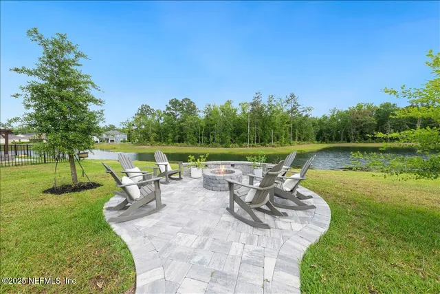 an aerial view of a house with swimming pool patio and outdoor seating