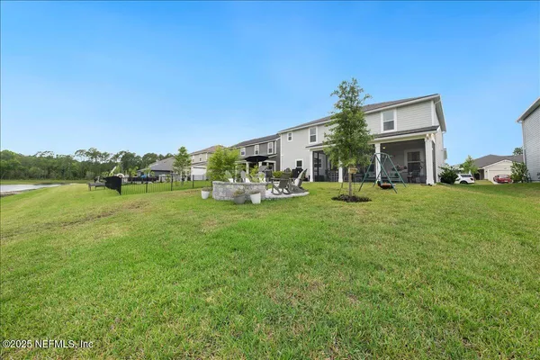 a view of a house with swimming pool and sitting area
