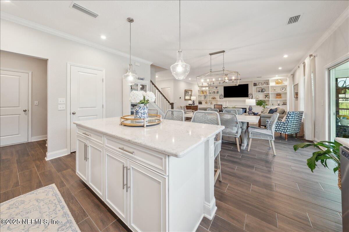 552 Meadow Creek Drive St. Johns, FL 32259 - Photo 10 of 62 a view of living room with kitchen island furniture and a flat screen tv