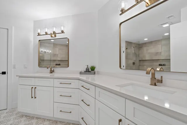 a bathroom with double vanity sink and a mirror