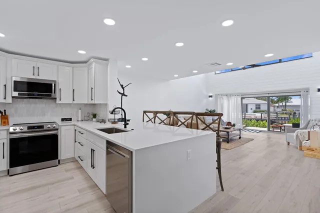 a view of a kitchen with sink and cabinets