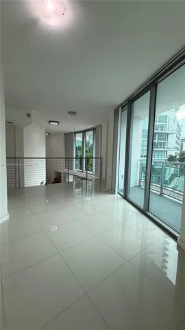 a view of a livingroom with furniture and floor to ceiling window