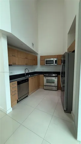 a kitchen with stainless steel appliances a stove and a refrigerator