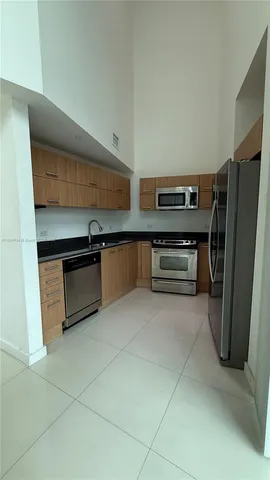 a kitchen with stainless steel appliances a stove and a refrigerator