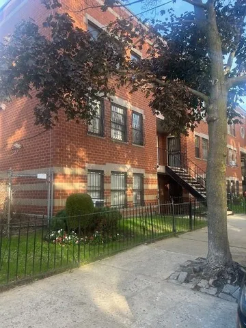a view of a house with a backyard and a tree