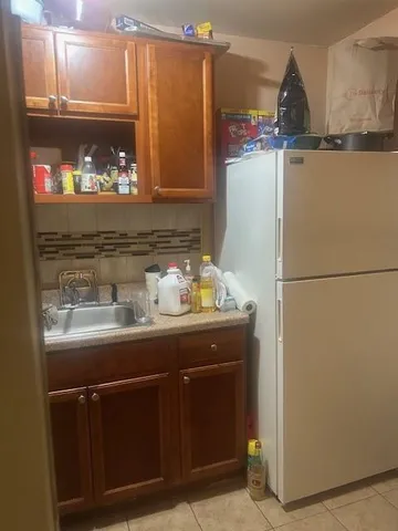 a kitchen with refrigerator and cabinets