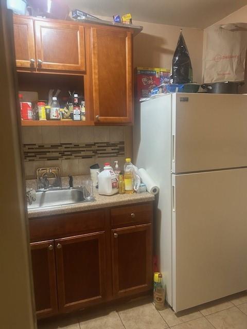 54 Veronica Place, Unit 1B Brooklyn, NY 11226 - Photo 2 of 12 a kitchen with refrigerator and cabinets