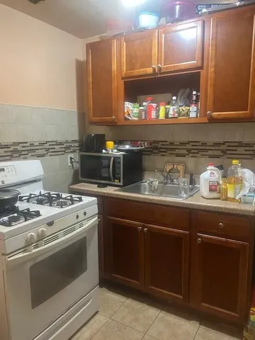 a stove top oven sitting inside of a kitchen