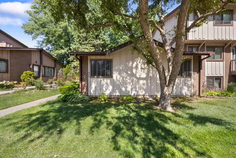 a backyard of a house with table and chairs