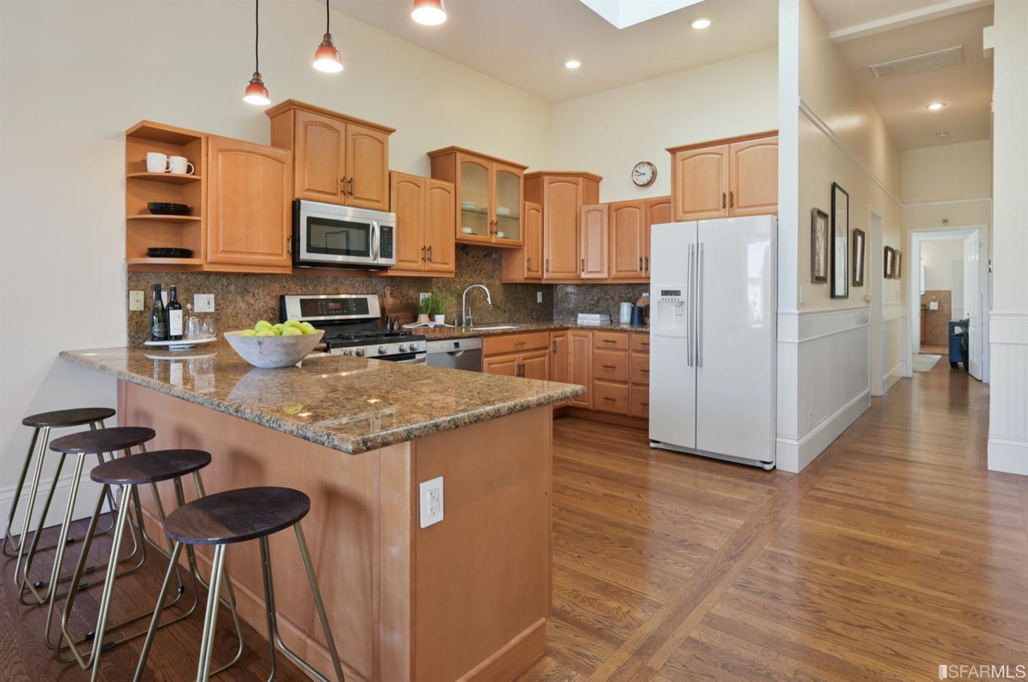 1663 Turk Street San Francisco, CA 94115 - Photo 12 of 27 a kitchen with stainless steel appliances granite countertop a refrigerator a stove and a wooden floors
