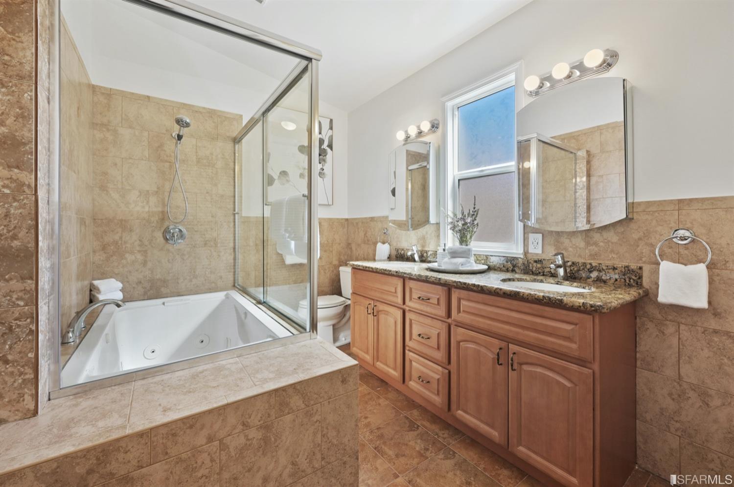 1663 Turk Street San Francisco, CA 94115 - Photo 18 of 27 a spacious bathroom with a granite countertop tub sink and mirror