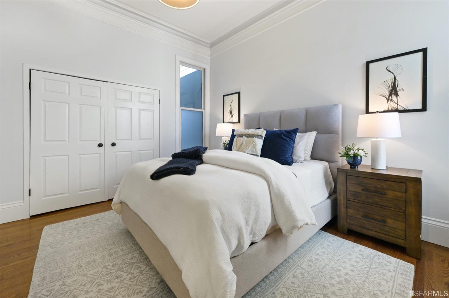 1663 Turk Street San Francisco, CA 94115 - Photo 24 of 27 a bedroom with a bed and a painting on the wall