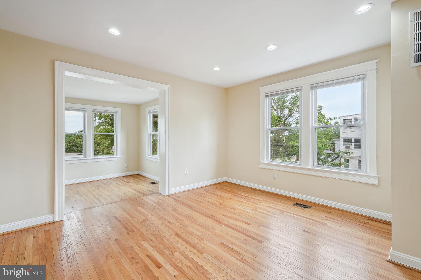 4528 4th Street Northwest Washington, DC 20011 - Photo 7 of 28 a view of an empty room with wooden floor and a window
